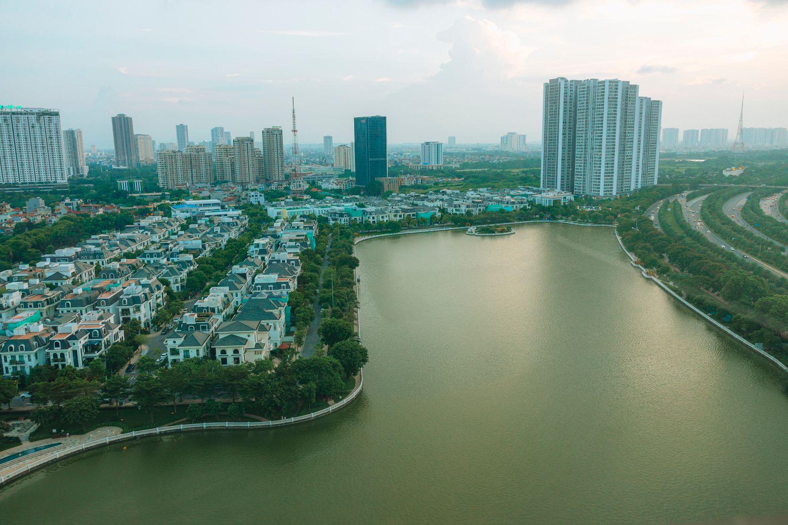 Khu nhà ở ven mặt nước rộng, phía xa là các toà nhà cao tầng